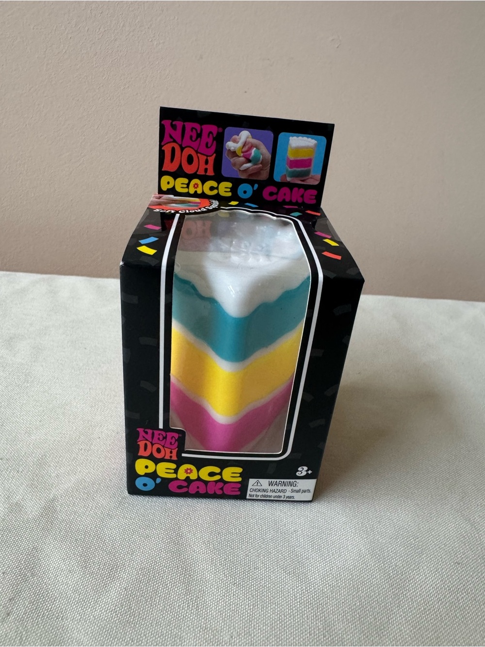 NeeDoh Nee Doh Peace O Cake Layered Squeezy Toy - Pink, Yellow, Blue, White